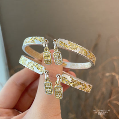 Gold-painted arabesque bracelet with peace and joy pattern