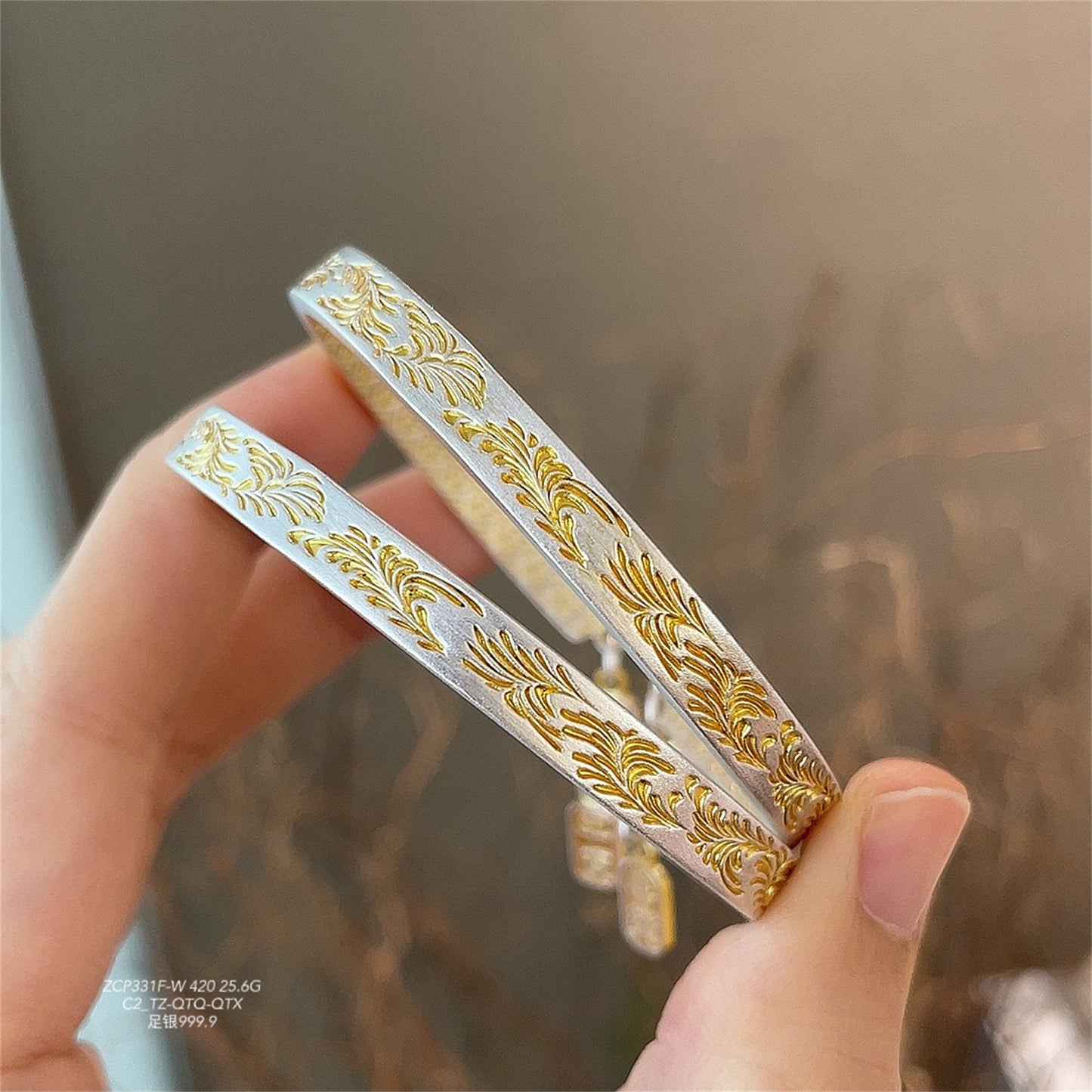 Gold-painted arabesque bracelet with peace and joy pattern