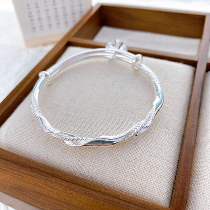 Wrapped bell sterling silver bracelet