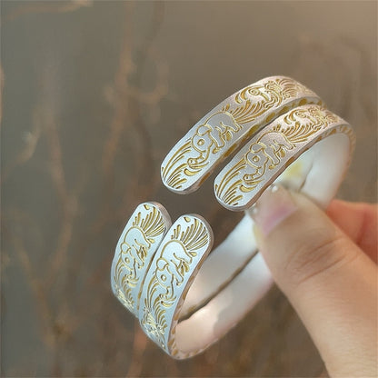 Solid bracelet with gold-painted lucky elephant and hammered pattern